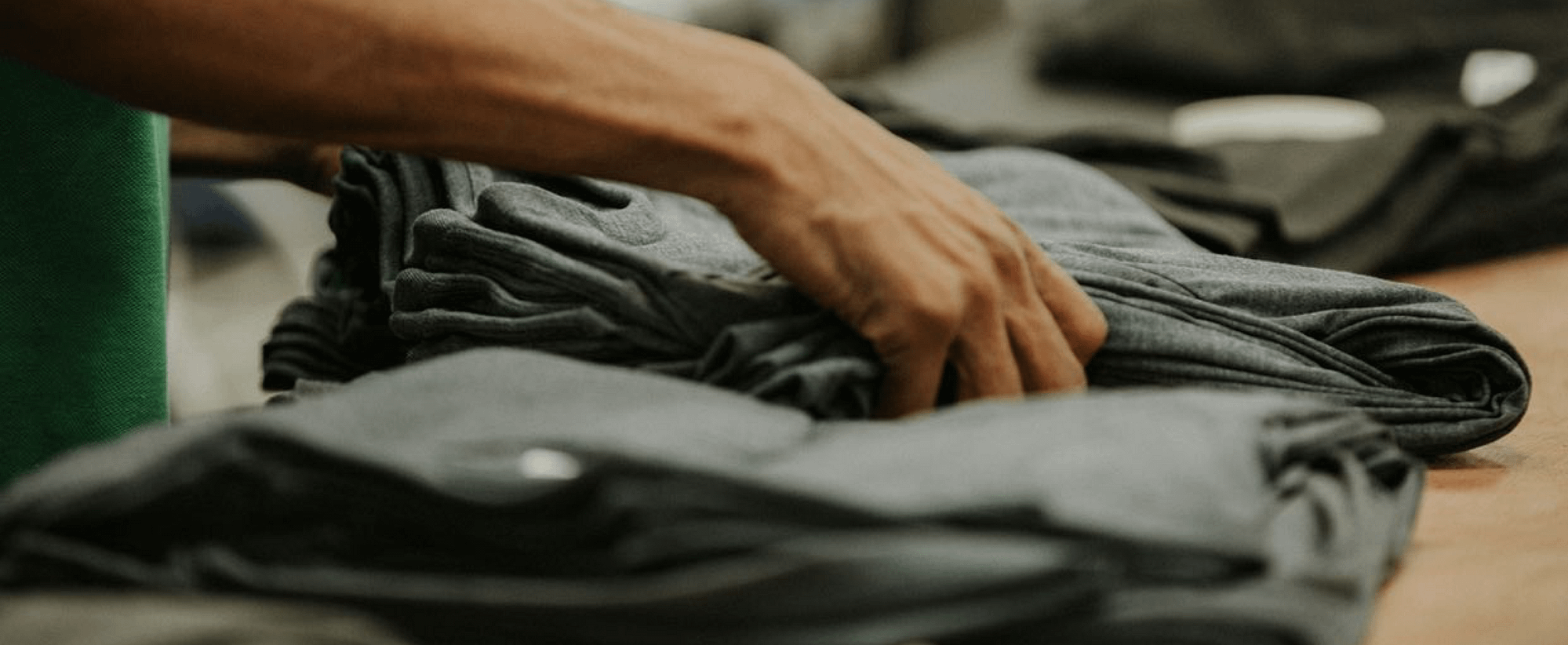 a stack of shirts being laid out on a table