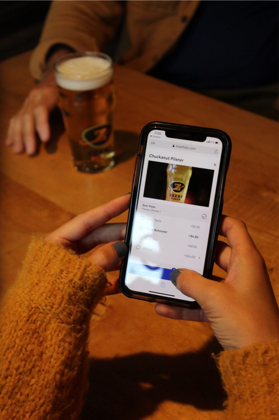 A customer using their smart phone to make an order