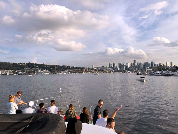 Mentor team enjoying the view of the seattle skyline from Aaron's boat deck