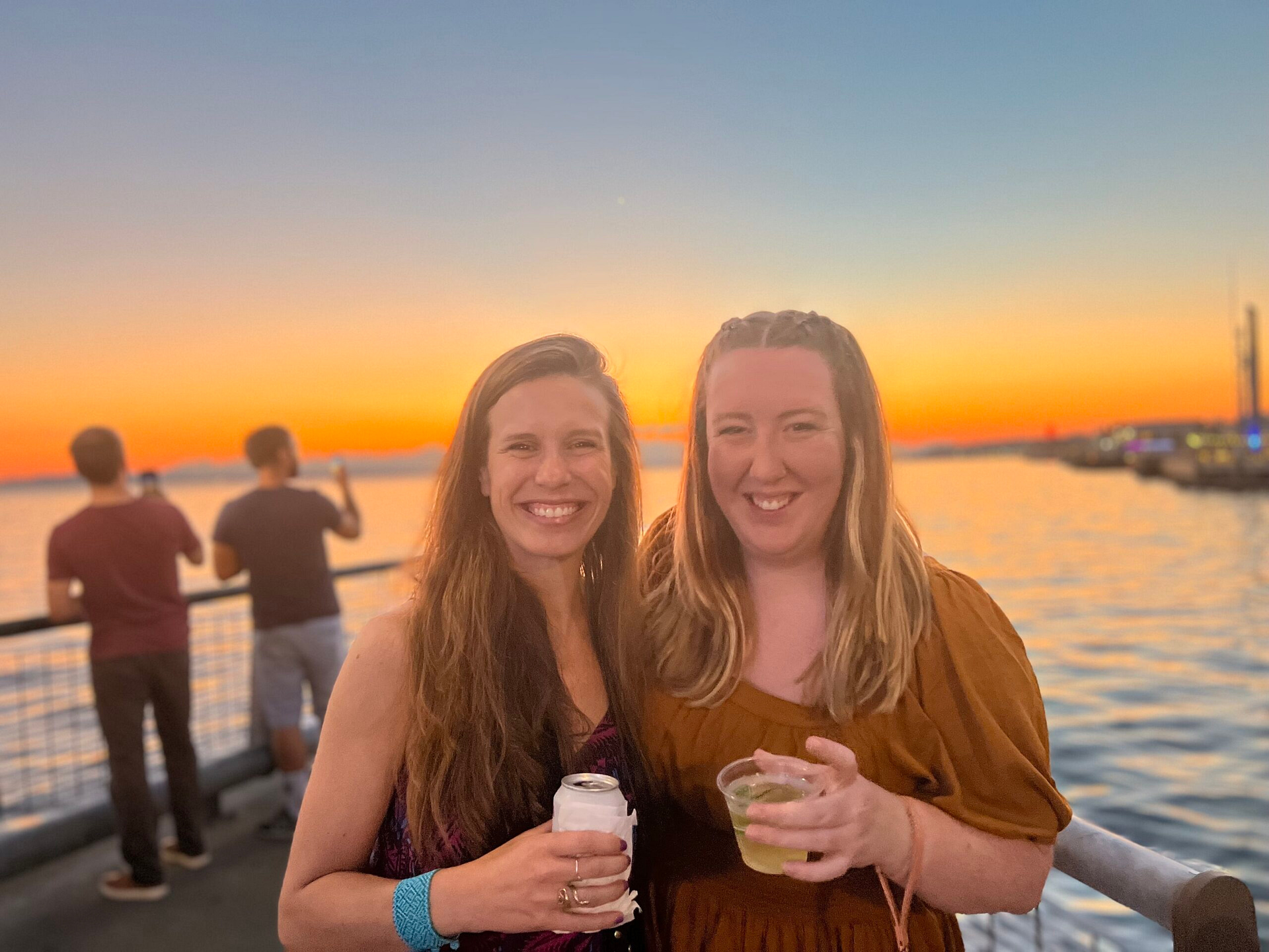 Britt and Lilly attending a Seattle waterfront event at sunset