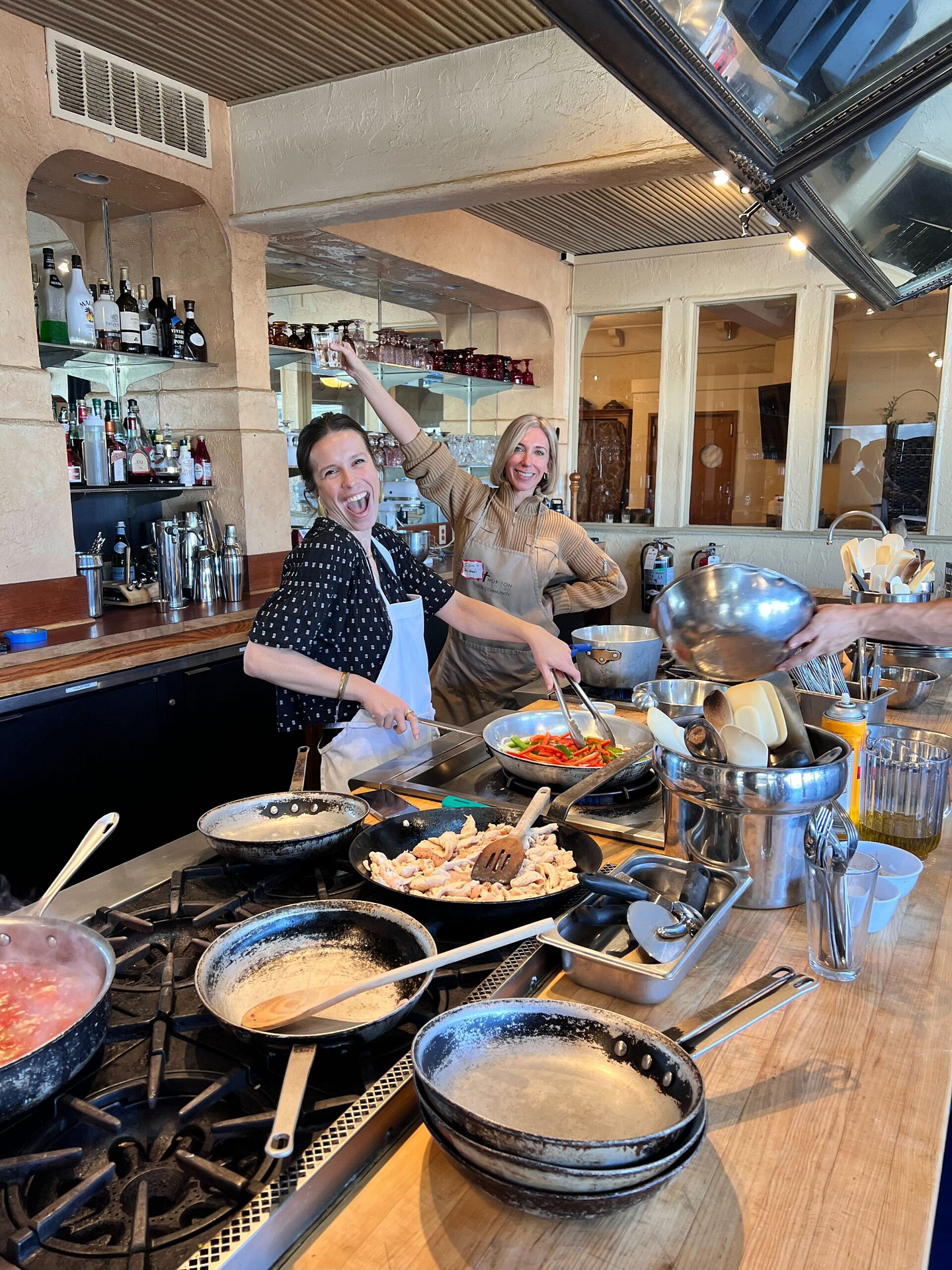2 mentor employees having fun at a cooking class
